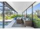 Inviting covered patio featuring comfortable seating with a view of the well-manicured lawn and surrounding greenery at 146 Rotonda Cir, Rotonda West, FL 33947