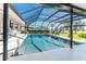 Stunning screened-in pool with lounge chairs, ideal for enjoying outdoor living and entertaining in style at 146 Rotonda Cir, Rotonda West, FL 33947