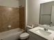 Updated bathroom with shower-tub combo and granite countertops on the vanity at 15417 Hanley Ct, Port Charlotte, FL 33953