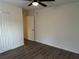 Well-lit bedroom featuring luxury vinyl floors and an updated ceiling fan at 15417 Hanley Ct, Port Charlotte, FL 33953