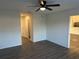 Clean and bright bedroom with ceiling fan, wood-look floors and easy access to closets and en-suite at 15417 Hanley Ct, Port Charlotte, FL 33953