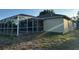 A backyard view of the home with a screened-in pool area at 15417 Hanley Ct, Port Charlotte, FL 33953