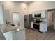 Well-lit kitchen featuring granite countertops, stainless steel appliances, and white cabinetry at 15417 Hanley Ct, Port Charlotte, FL 33953