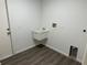 Laundry room featuring vinyl flooring and a utility sink at 15417 Hanley Ct, Port Charlotte, FL 33953