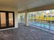Covered patio with brick pavers leading to a screened-in pool area for outdoor enjoyment at 15417 Hanley Ct, Port Charlotte, FL 33953