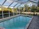 Screened-in lanai with swimming pool offers a refreshing outdoor space with lots of privacy at 15417 Hanley Ct, Port Charlotte, FL 33953