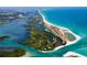 Breathtaking aerial view showcasing the coastline, white sand beaches, and turquoise waters at 180 N Gulf Blvd # 5, Placida, FL 33946