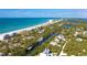 A beautiful aerial view of the coastline with stunning turquoise water, beaches, and waterfront homes at 180 N Gulf Blvd # 5, Placida, FL 33946