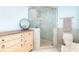 Elegant bathroom boasts a frameless glass shower and custom vanity with marble countertop at 180 N Gulf Blvd # 5, Placida, FL 33946