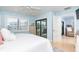Bright bedroom with a large window, closet, and door leading to the living room at 180 N Gulf Blvd # 5, Placida, FL 33946