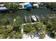 Aerial view of boat dock and lift surrounded by lush greenery, offering convenient waterfront access at 180 N Gulf Blvd # 5, Placida, FL 33946
