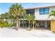 Charming beach house with mature palm trees, light siding, and covered parking at 180 N Gulf Blvd # 5, Placida, FL 33946