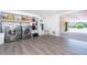 Large laundry room and storage area with newer washer and dryer, sink, and folding area at 180 N Gulf Blvd # 5, Placida, FL 33946