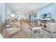 Open-concept living area with plush recliners, entertainment center, and kitchen views at 180 N Gulf Blvd # 5, Placida, FL 33946
