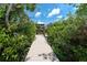 Inviting boardwalk through lush greenery leads to the house at 180 N Gulf Blvd # 5, Placida, FL 33946