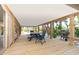 Spacious, covered outdoor patio with dining and grilling areas surrounded by lush landscaping at 180 N Gulf Blvd # 5, Placida, FL 33946