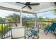 Inviting screened lanai with cozy seating and views of the lush landscaping in the area at 180 N Gulf Blvd # 5, Placida, FL 33946