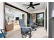 Cozy outdoor seating with view, with two swivel chairs on screened porch with a ceiling fan at 180 N Gulf Blvd # 5, Placida, FL 33946