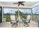Relaxing screened-in porch with comfortable swivel chairs and a beautiful neighborhood view at 180 N Gulf Blvd # 5, Placida, FL 33946
