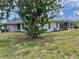 Rear exterior view of the home, highlighting the screened pool area and connecting backyard at 22589 Nyack Ave, Port Charlotte, FL 33952