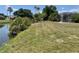 Expansive waterfront backyard with lush landscaping, canal access, and potential for outdoor living at 22589 Nyack Ave, Port Charlotte, FL 33952
