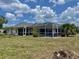 Spacious screened-in pool area surrounded by lush landscaping, perfect for outdoor entertainment and relaxation at 22589 Nyack Ave, Port Charlotte, FL 33952
