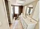 Bathroom with a white vanity, tile floor, large mirror, toilet, and tiled shower at 22589 Nyack Ave, Port Charlotte, FL 33952