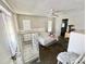 Spacious bedroom featuring a ceiling fan, sliding glass doors, and a walk-in closet at 22589 Nyack Ave, Port Charlotte, FL 33952