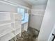 Walk-in closet featuring built-in shelving and a window at 22589 Nyack Ave, Port Charlotte, FL 33952