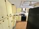 Outdated kitchen with yellow cabinets, laminate countertops, and black appliances at 22589 Nyack Ave, Port Charlotte, FL 33952