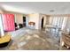 Empty living room, featuring pink walls, table with chairs and a bright red front door at 22589 Nyack Ave, Port Charlotte, FL 33952