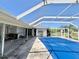 View of the screened-in pool area and the exterior of the home at 22589 Nyack Ave, Port Charlotte, FL 33952