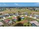 A lovely aerial view of the property with pond access and golf course view at 23 Bunker Cir, Rotonda West, FL 33947
