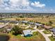 A bird's-eye view shows the home's location amidst a lush, green landscape and established neighborhood at 23 Bunker Cir, Rotonda West, FL 33947