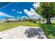 Spacious backyard featuring a patio and water view, perfect for outdoor enjoyment and relaxation at 23 Bunker Cir, Rotonda West, FL 33947