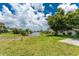 Lush green backyard offering a serene view of the canal, enhancing the property's tranquility at 23 Bunker Cir, Rotonda West, FL 33947