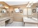 Bright ensuite bathroom with vanity, storage, tile floors, and large mirrors at 23 Bunker Cir, Rotonda West, FL 33947