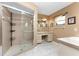 Bright ensuite bathroom with vanity, storage, walk-in glass shower, and tile floors at 23 Bunker Cir, Rotonda West, FL 33947