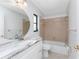 Bathroom featuring vanity with marble countertop, coordinated tile in shower and tub at 23 Bunker Cir, Rotonda West, FL 33947