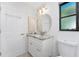 Bathroom with marble countertop vanity and drawers plus a large round mirror at 23 Bunker Cir, Rotonda West, FL 33947