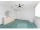 Spacious bedroom with ceiling fan, neutral walls, green carpet, and ample natural light from the window at 23 Bunker Cir, Rotonda West, FL 33947