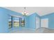 Open dining area with large bay window and neutral tile flooring at 23 Bunker Cir, Rotonda West, FL 33947