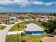 Aerial view of a bright blue home in a residential community at 23 Bunker Cir, Rotonda West, FL 33947