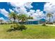 Charming home featuring a well-manicured lawn and inviting curb appeal with mature palms at 23 Bunker Cir, Rotonda West, FL 33947