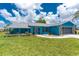 Attractive single-Gathering home featuring landscaping, a well-kept lawn, and a welcoming entrance at 23 Bunker Cir, Rotonda West, FL 33947