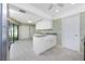 Bright kitchen with white cabinetry, stainless steel appliances, granite countertops, and backyard access at 23 Bunker Cir, Rotonda West, FL 33947