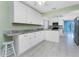 Bright kitchen with white cabinets, granite countertops, and an island with seating at 23 Bunker Cir, Rotonda West, FL 33947