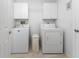 Bright laundry room with a washer and dryer and additional storage cabinets at 23 Bunker Cir, Rotonda West, FL 33947