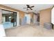 Spacious main bedroom with carpet, large windows, sliding glass doors, ceiling fan, and ensuite bathroom at 23 Bunker Cir, Rotonda West, FL 33947