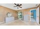 Spacious main bedroom with carpet, large windows, sliding glass doors, ceiling fan, and ensuite bathroom at 23 Bunker Cir, Rotonda West, FL 33947
